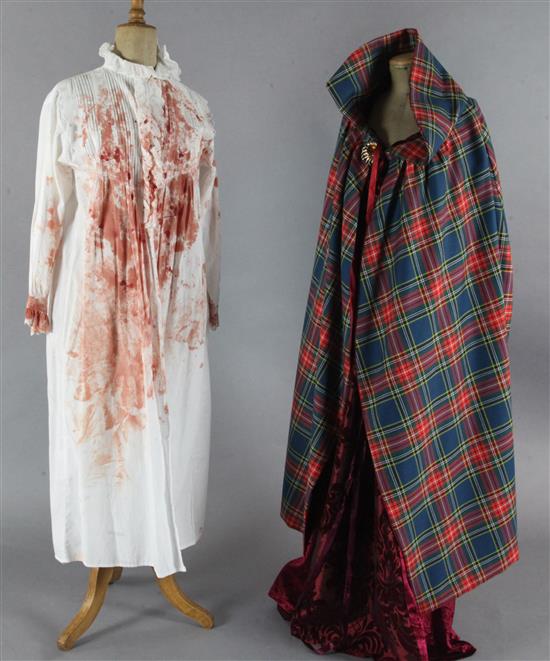 Macbeth: A rail with various tunics with Royal coat of arms, crosses, dragons, fleur dLys etc., blooded nightshirts,